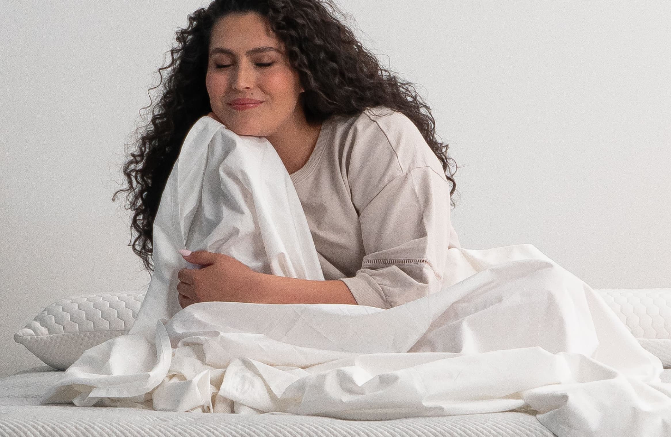 Female enjoying the Leesa white bedding sheets